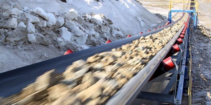 Ore moving on a conveyor belt in a mining operation